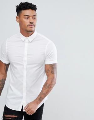 Белая узкая хлопковая рубашка с короткими рукавами Armani Exchange. Цвет: белый